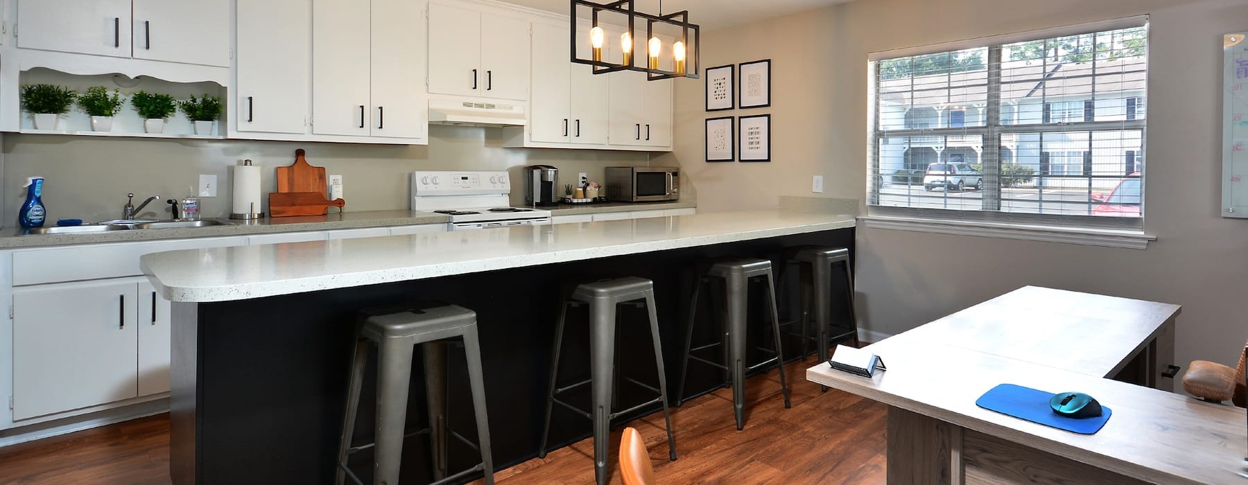 kitchen with modern bar seating and a large bar with natural lighting from windows